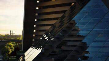 CGI Modern architectural structures reflect sunlight in an urban setting at dawn video