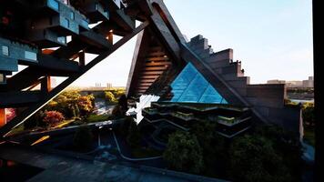CGI Modern architectural marvel with unique angles and vibrant greenery at sunset video