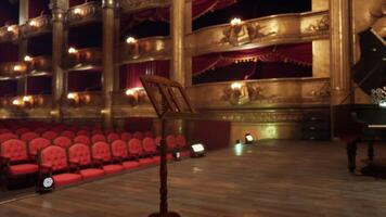 CGI Old opera house interior featuring empty red seats and a music stand on stage video