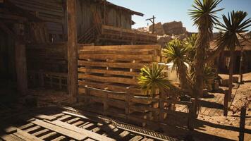 CGI Deserted wooden structures surrounded by sparse vegetation in a sunlit canyon video