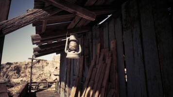 CGI Rustic lantern hanging from wooden structure in a deserted mining town video