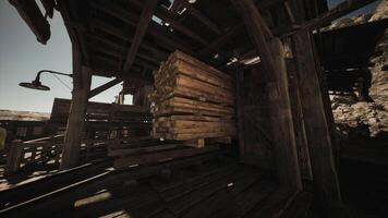 CGI Stacks of wooden planks are neatly arranged within a dimly lit, rustic building video