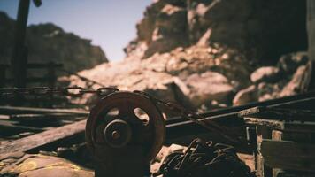 CGI Abandoned mine with rusted tools and mountains in daylight video