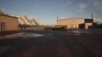 CGI Abandoned industrial area with large structures under clear blue sky at sunset video