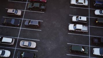 CGI Aerial view of a nearly empty parking lot with various parked vehicles at dusk video