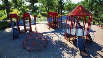 CGI Bright playground equipment in a sunny park with trees and slides video