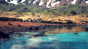 CGI Serene mountain lake reflecting snow capped peaks at dawn video