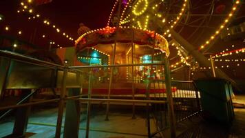 CGI An empty amusement park at night with illuminated carousel and twinkling lights video
