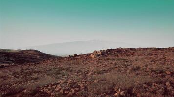 CGI Serene landscape view of rocky terrain and distant mountains at sunrise video