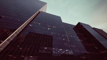 CGI Modern glass skyscrapers reflect the evening sky in an urban setting video