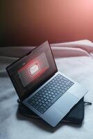 Cyber security on internet concept. Email spam notification alert with warning caution on laptop scree. Compromised information. photo