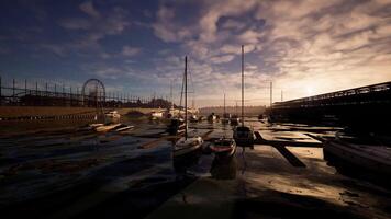 CGI Harbor at sunset with boats docked and a distant amusement park in view video