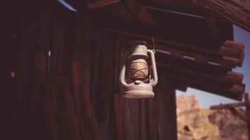 CGI Old rustic lantern hanging from a wooden structure in a desert landscape video