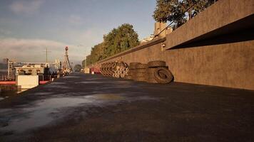 CGI View of stacked tires along a waterfront promenade during the sunset video