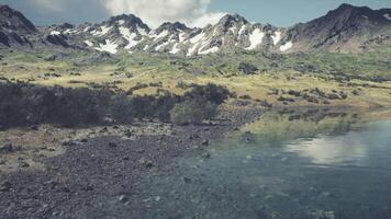 CGI Scenic mountainous landscape with a tranquil lake reflecting clouds video