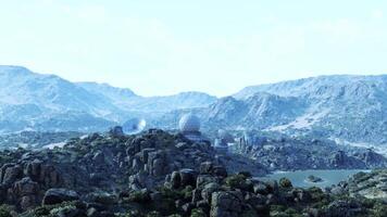CGI Military base located in rugged mountains with satellite dishes and lake view video