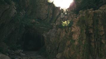 CGI Exploring a serene cave entrance in Indonesia during the golden hour video