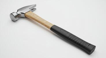 A hammer on a white surface with a wooden handle photo