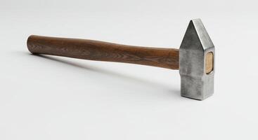 A hammer with a wooden handle on a white surface photo