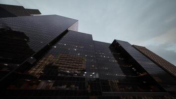 CGI Modern skyscrapers reflecting a cloudy sky in a bustling urban environment video