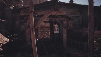 CGI Rustic lantern hanging outside an old mine entrance in a desert landscape video