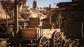 CGI Old wooden cart rests in a dusty western town under bright sunlight video