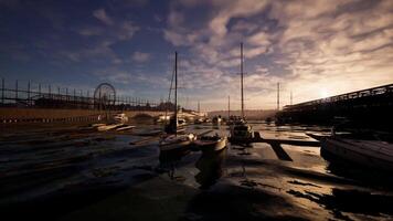 CGI Boats docked at sunset with a ferris wheel in the background at the waterfront video