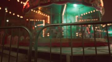 CGI Empty amusement park at night with illuminated carousel and gated attractions video
