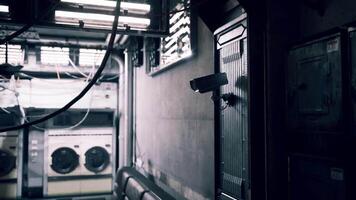 CGI Surveillance camera watching over a dimly lit laundry room with machines video