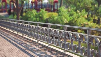 CGI A decorative railing along a scenic path in a vibrant park during daytime video