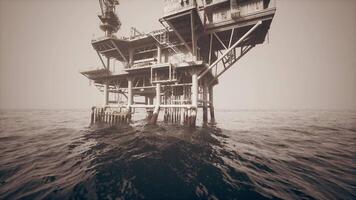 CGI Old oil platform standing in the ocean under a cloudy sky at dusk video