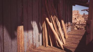 CGI Wooden planks lean against a rustic structure in a sunlit desert setting video