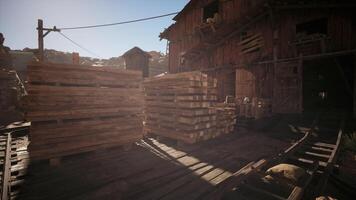 CGI Wooden pallets stacked outside an old mining structure in the afternoon light video