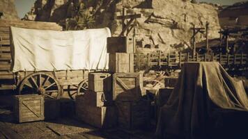 CGI Rustic wooden crates and wagon in a dusty southwestern landscape during sunset video