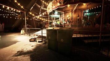 CGI Empty amusement park at night with illuminated carousel and trash bins video
