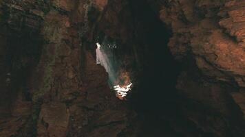 CGI Exploring a vast cave with sunlight breaking through at midday video