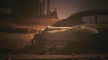 CGI Abandoned vintage car rusting in a desolate overgrown landscape at dusk video
