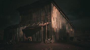 CGI Wooden barn illuminated under a dramatic sky near a dirt road in twilight video