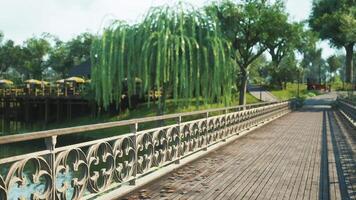 CGI Scenic riverside pathway with willow trees and dining area under blue sky video