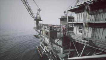 CGI Old oil platform standing in the ocean with cranes at twilight video
