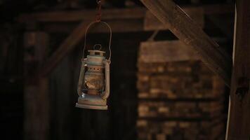 CGI Vintage oil lantern hanging in a rustic wooden shed during the evening hours video