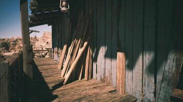 CGI Rustic wooden building with sunlit porch and stacked planks in the desert video