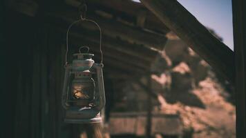 CGI Rustic lantern hanging outside an old cabin in the mountains at dusk video