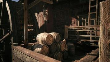 CGI Old wooden barrels stacked near a water wheel in a rustic setting video
