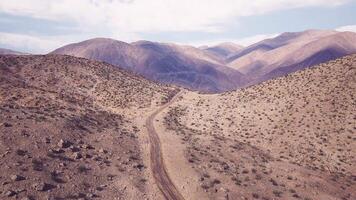 CGI Vast desert landscape with winding road and distant mountain ranges video