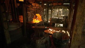 CGI Old forge with glowing embers and wooden tools in a rustic workshop video