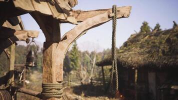 CGI Rope hanging from a wooden structure in a rustic village setting video