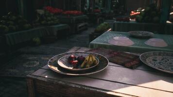 CGI Fresh fruits on decorative plates at a bustling outdoor market setting video
