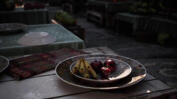 CGI Fruit bowl on a rustic table with blurred market background at midday video