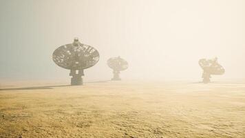 CGI Satellite dishes stand tall on an alien landscape under a hazy sky video